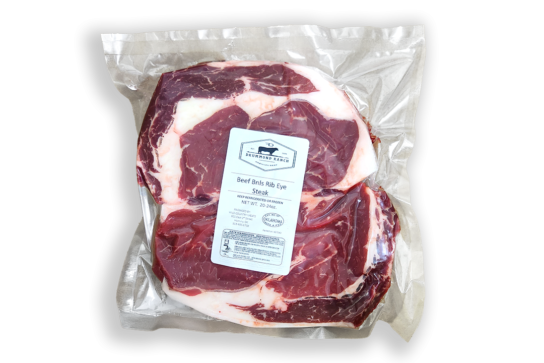 Vacuum-sealed package of Drummond Ranch boneless ribeye steak, featuring rich marbling and a label indicating premium beef sourced and processed in Oklahoma.